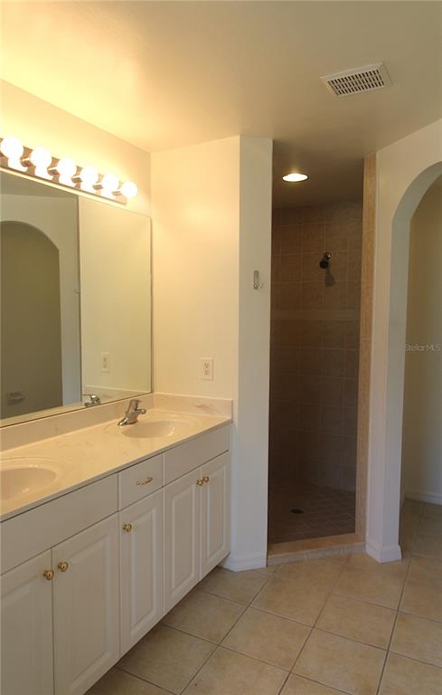1489 Exchange Avenue North Port, FL 34288 - Photo 14 of 25 a bathroom with a double vanity sink and mirror