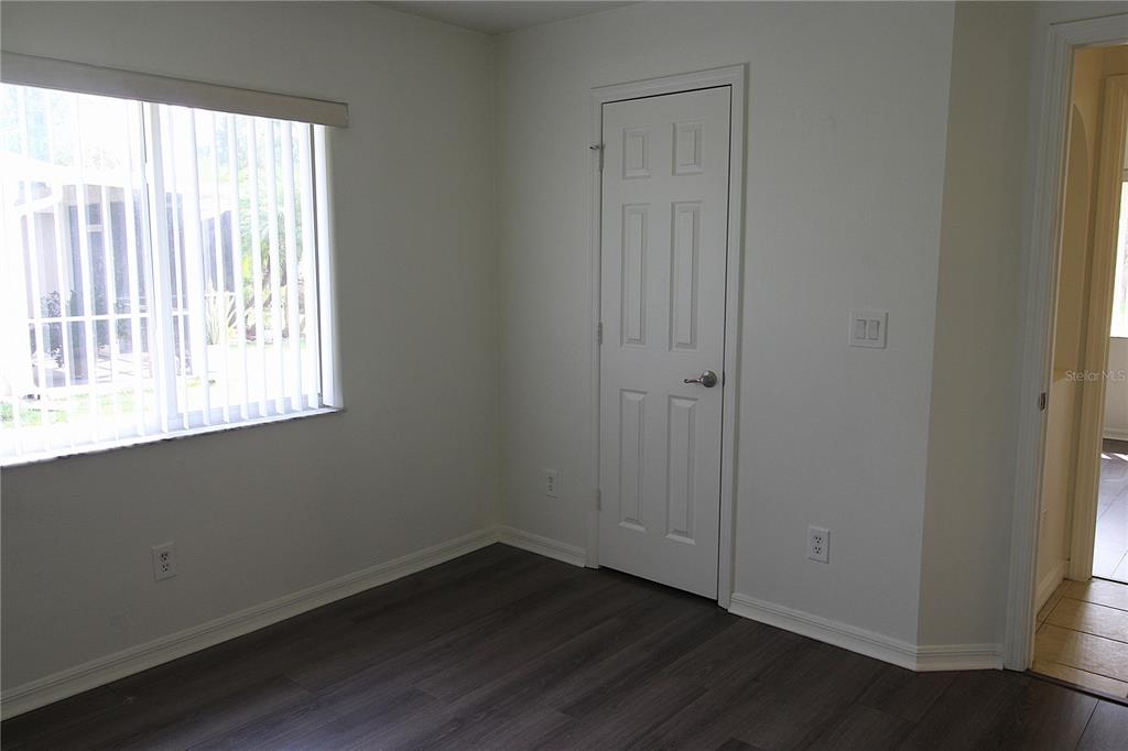 1489 Exchange Avenue North Port, FL 34288 - Photo 16 of 25 an empty room with wooden floor and windows