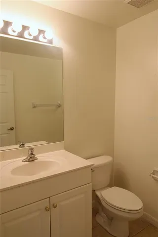 a bathroom with a sink a toilet and mirror