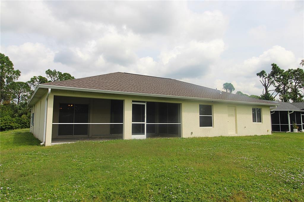 1489 Exchange Avenue North Port, FL 34288 - Photo 25 of 25 a view of a house with a yard