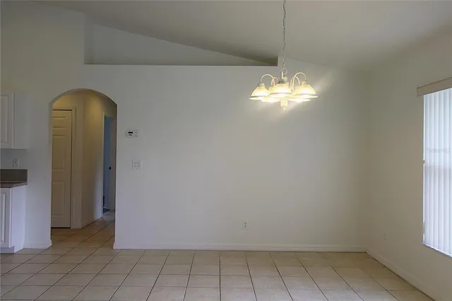 a room with window and a chandelier