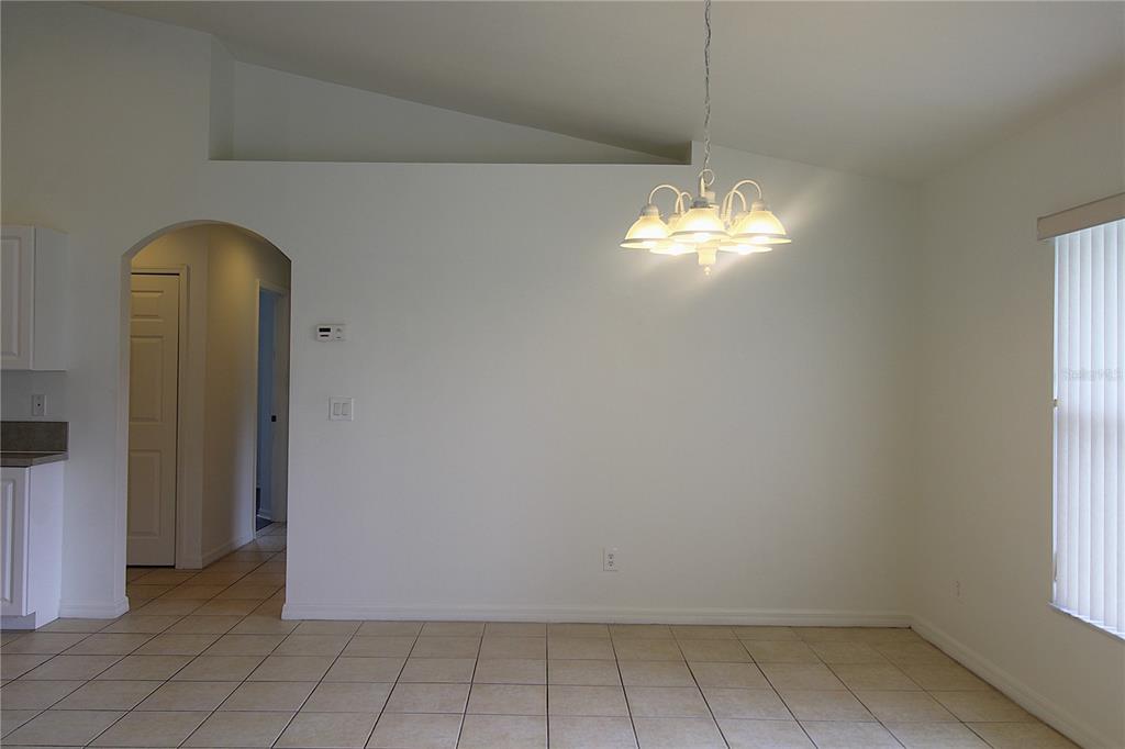 1489 Exchange Avenue North Port, FL 34288 - Photo 4 of 25 a room with window and a chandelier
