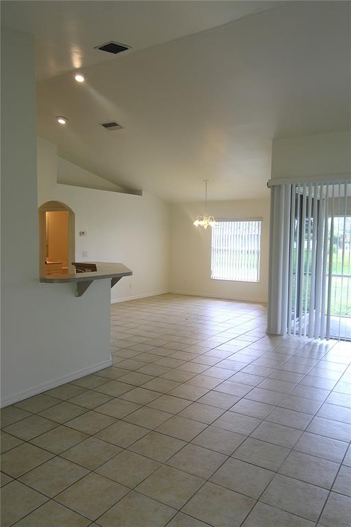 1489 Exchange Avenue North Port, FL 34288 - Photo 6 of 25 an empty room with wooden floor and windows