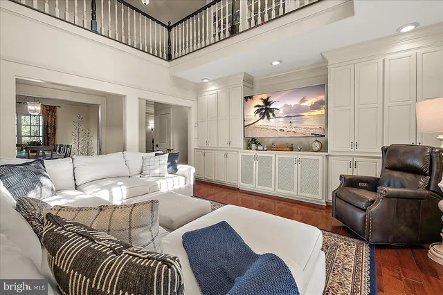 a kitchen with kitchen island a stove a refrigerator and a cabinets with wooden floor