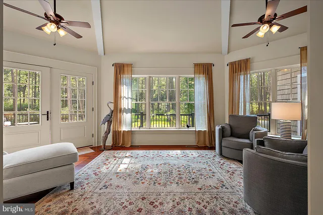 a living room with furniture fireplace and wooden floor