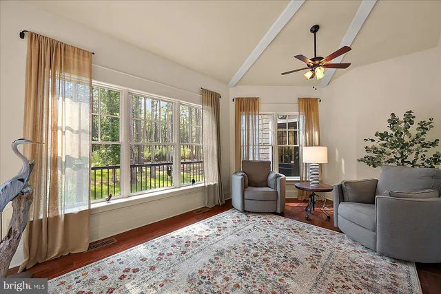 a view of a hallway with wooden floor and stairs