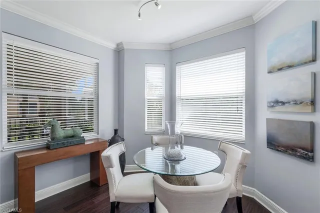 a dining room with furniture and windows