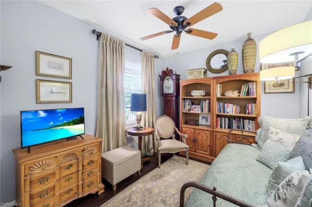 a living room with furniture a flat screen tv and a window