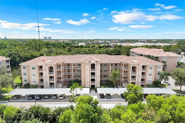 a front view of a residential apartment building with a yard