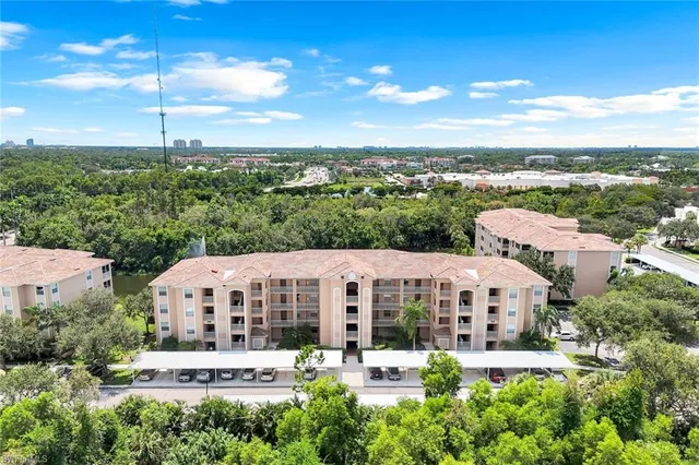 a large building with a big yard and large trees