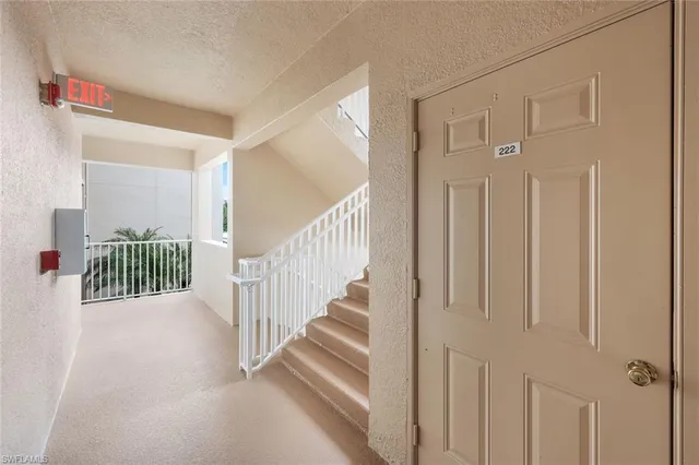 a view of a hallway with a door of a house