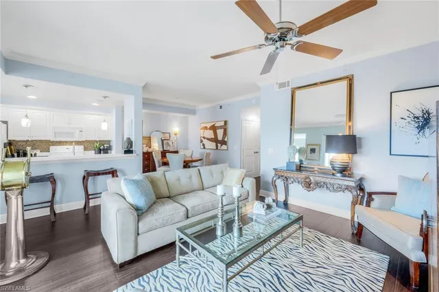 a living room with furniture and kitchen view