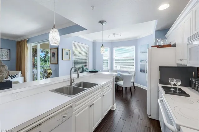 a kitchen with sink and refrigerator