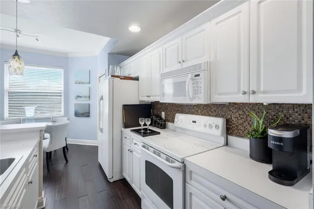 a kitchen with a stove a sink and a refrigerator