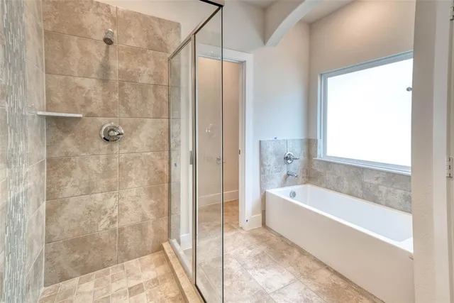 a bathroom with a bathtub and a shower
