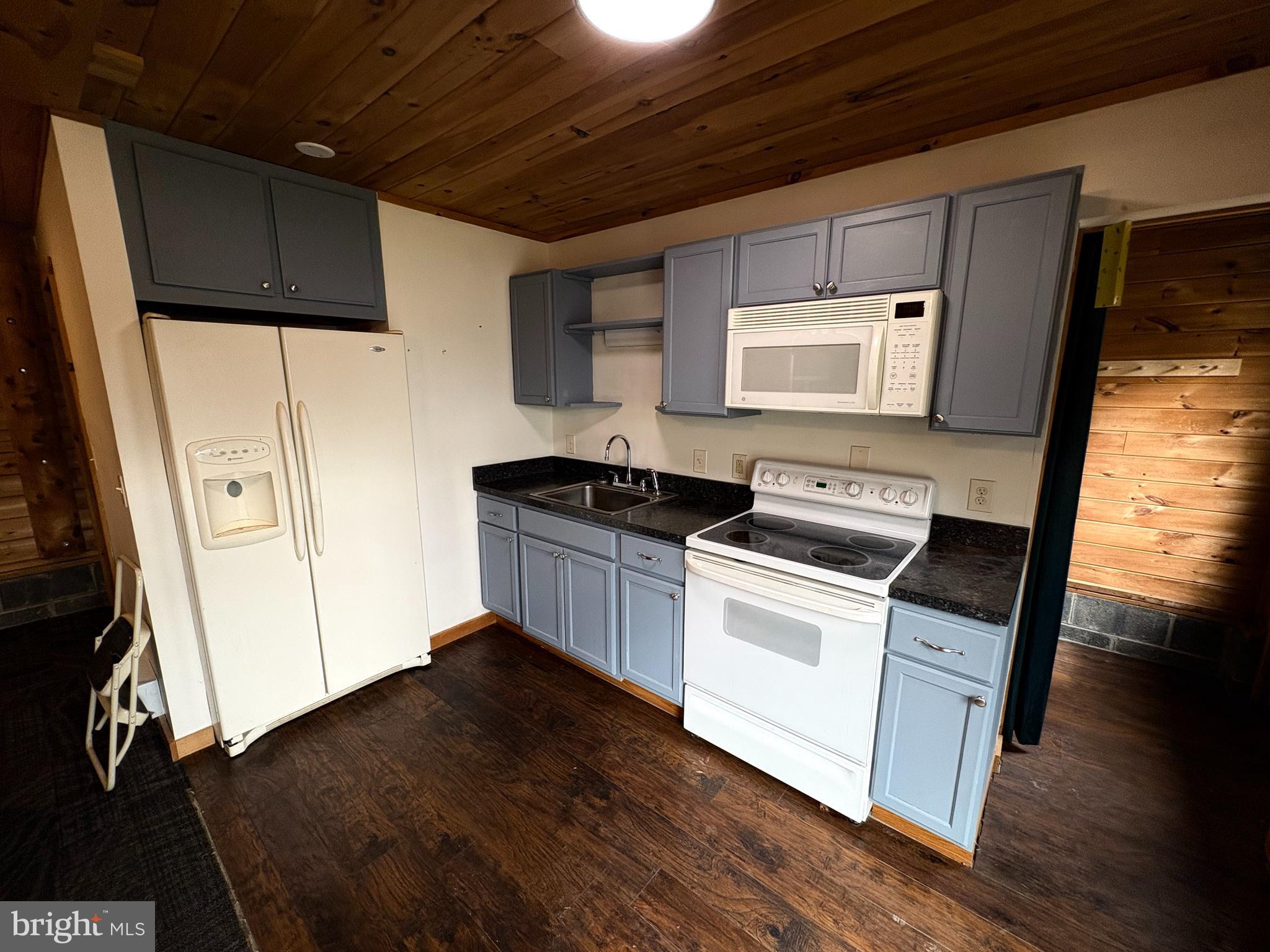 1400 Core Road Romney, WV 26757 - Photo 57 of 73 a kitchen with a sink a wooden floor and white cabinets