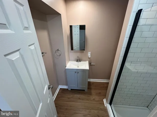 a bathroom with white sink and a mirror