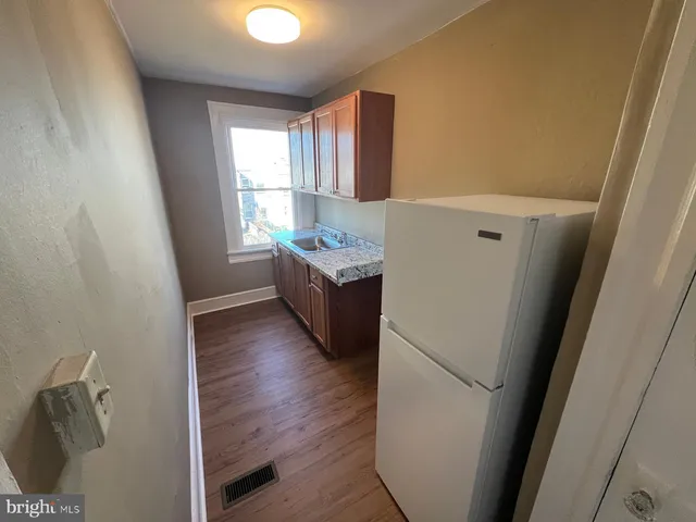 a kitchen with a sink a window and cabinets