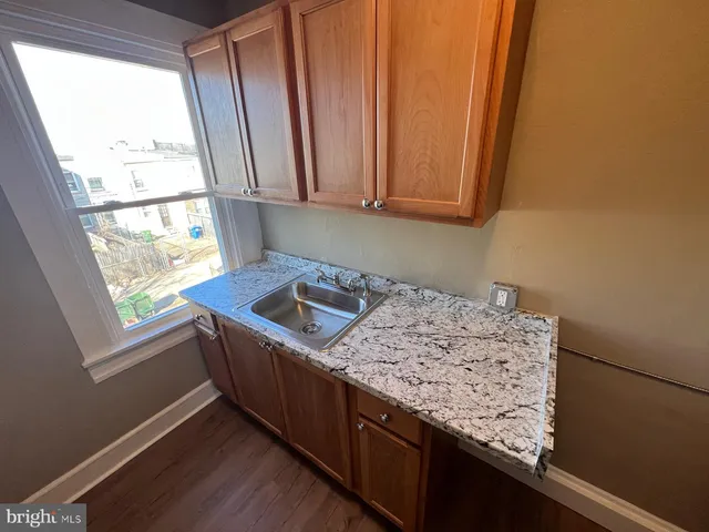a view of kitchen with wooden floor and chair