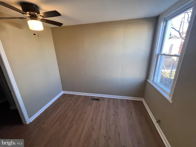 wooden floor in an empty room with a window