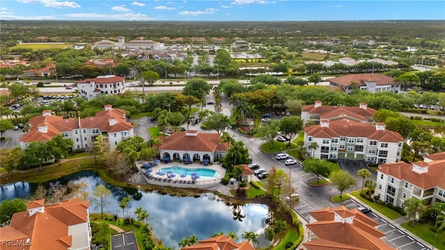 an aerial view of residential houses with outdoor space and river