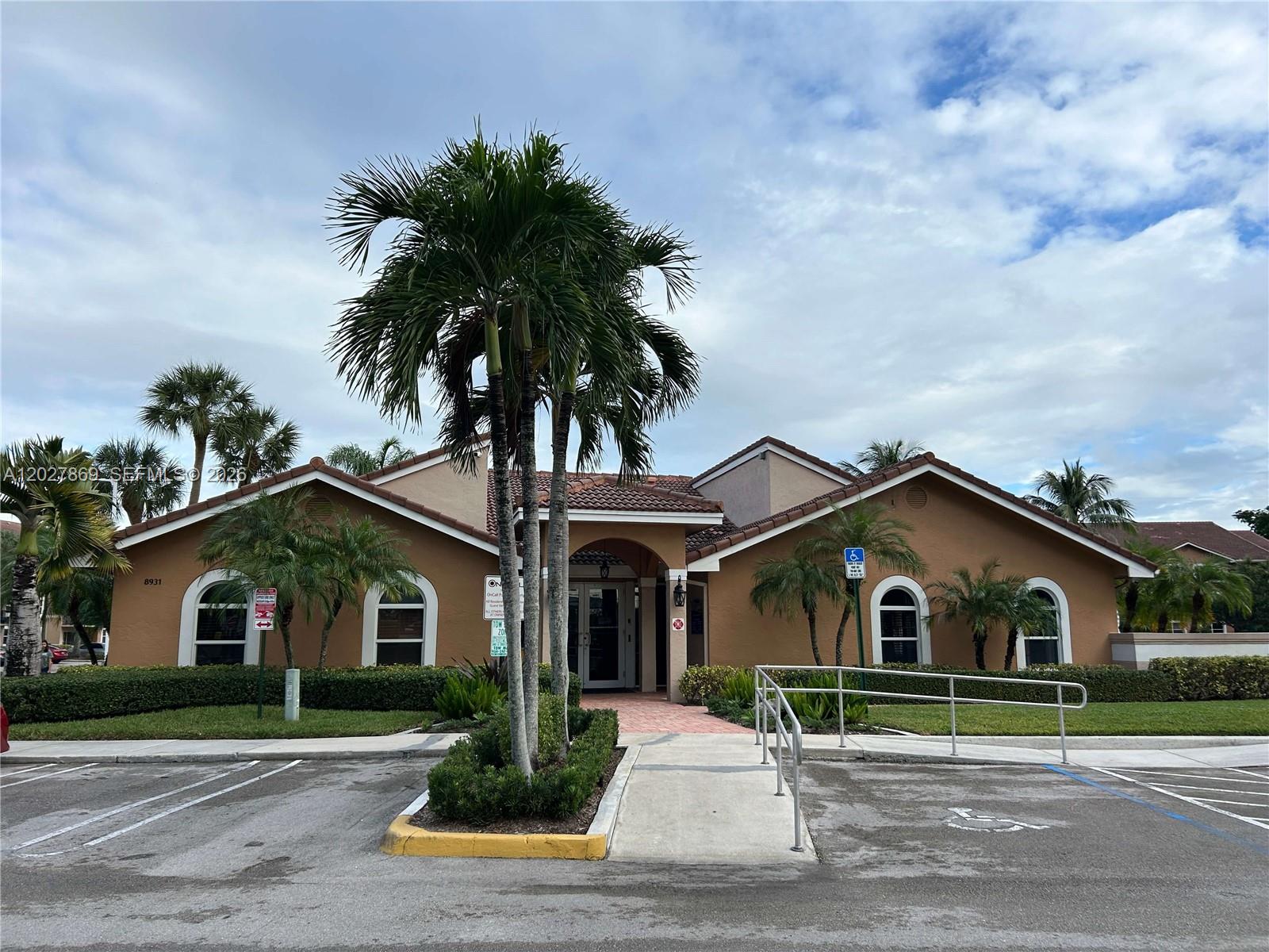 8761 Wiles Road, Unit 206 Coral Springs, FL 33067 - Photo 22 of 26 a front view of house with yard and green space