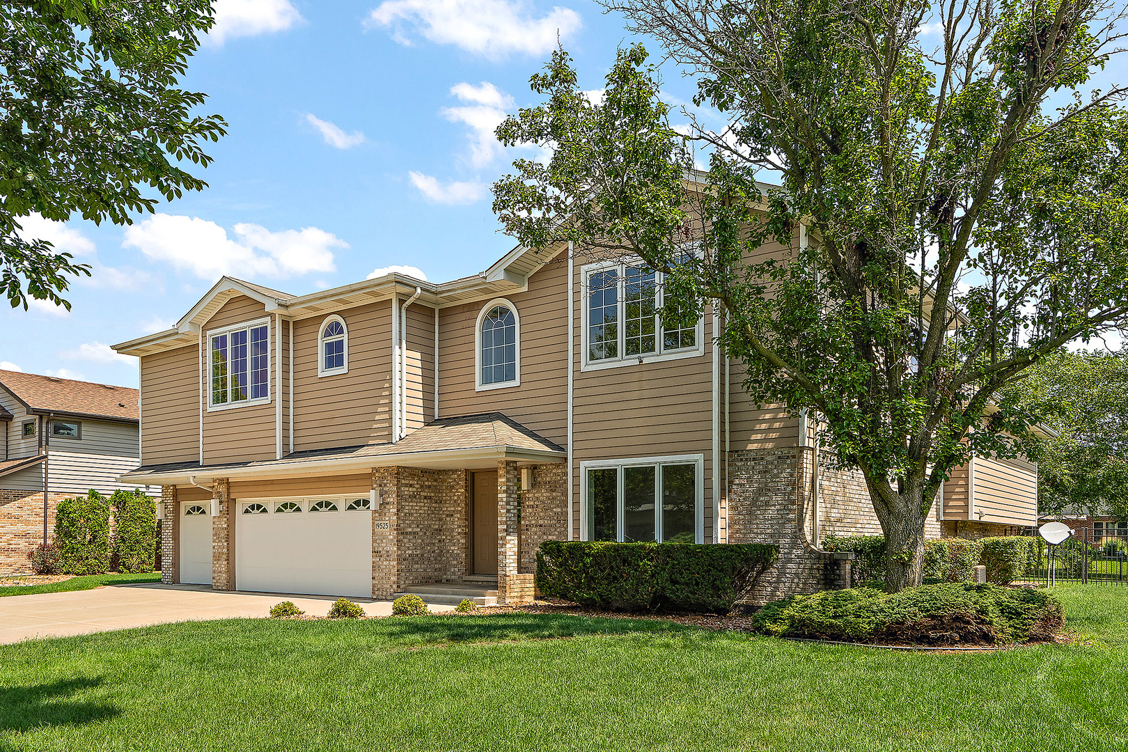 front view of a house with a tree in a yard