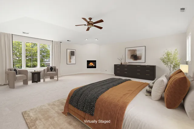 a spacious bedroom with a bed and a couch