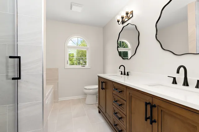 a bathroom with a double vanity sink and a mirror