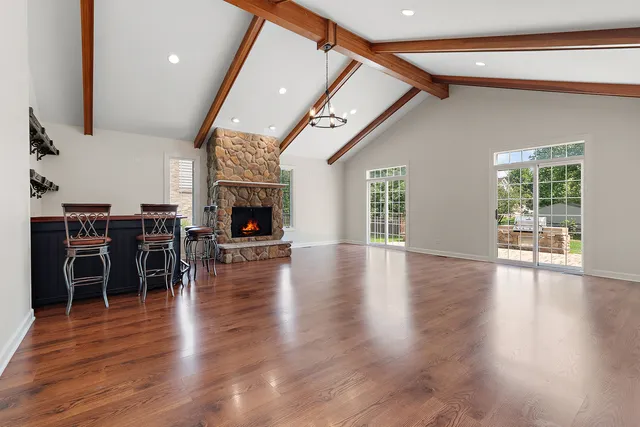 an open kitchen with furniture and wooden floor