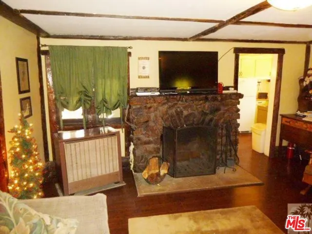 a living room with fireplace furniture and a flat screen tv