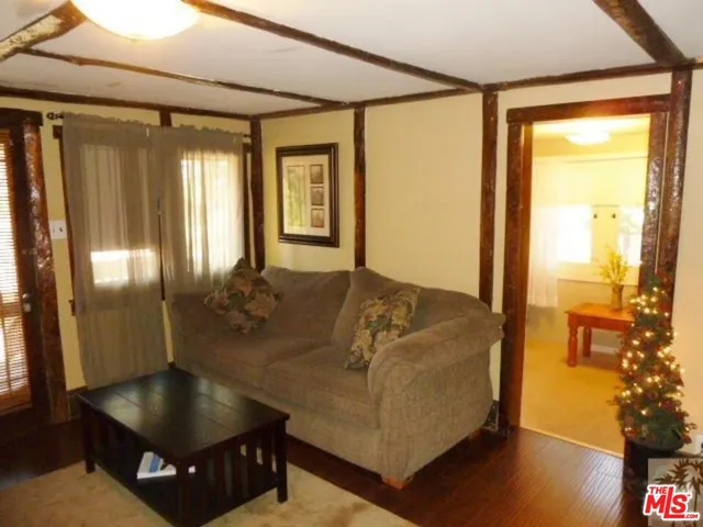 a living room with couch and a potted plant