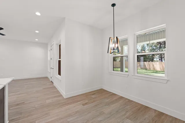 wooden floor in an empty room with a window