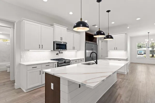 a front view of house with yard and trees in the background