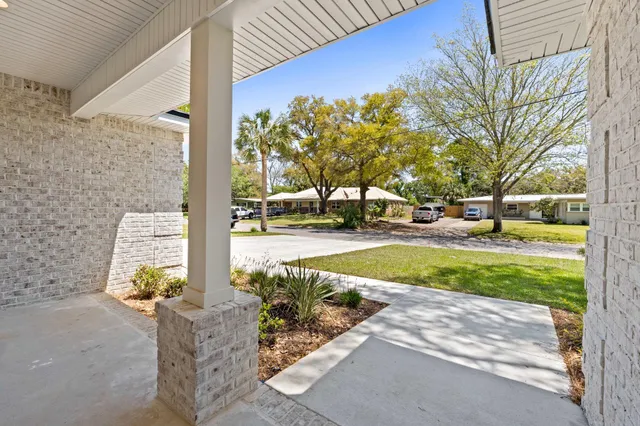 a living room with furniture kitchen view and a flat screen tv