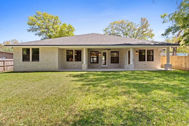 an empty room with window and wooden floor