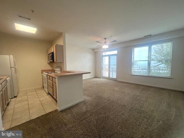 9000 Bay Avenue, Unit 106 North Beach, MD 20714 - Photo 3 of 12 a view of a kitchen with furniture and a window