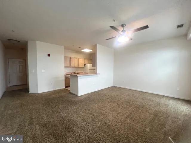 a view of a kitchen with a sink and cabinet area