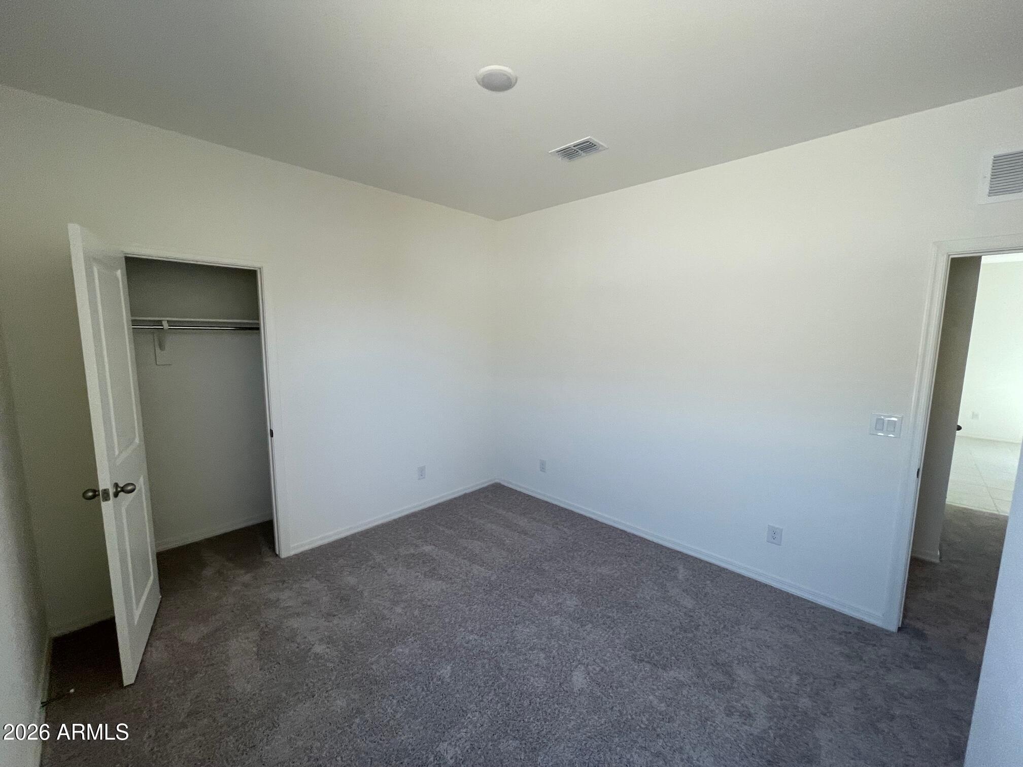 31632 Rodeo Road San Tan Valley, AZ 85140 - Photo 6 of 14 an empty room with a door