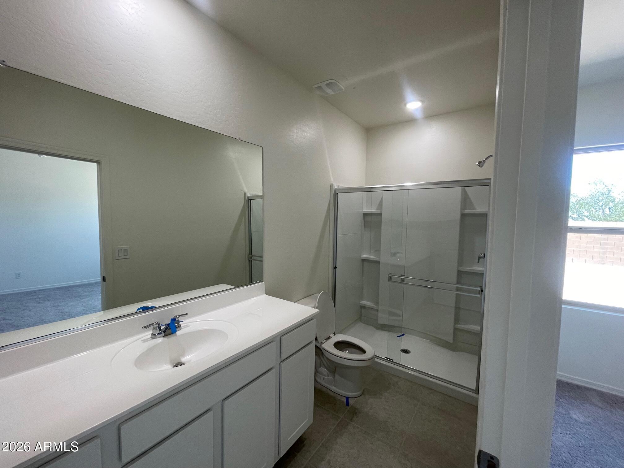 31632 Rodeo Road San Tan Valley, AZ 85140 - Photo 8 of 14 a bathroom with a shower sink mirror and toilet