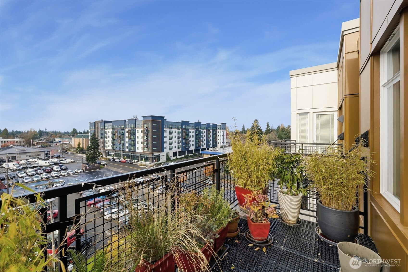 15100 6th Avenue Southwest, Unit 723 Burien, WA 98166 - Photo 14 of 23 a view of a balcony with chairs and potted plants