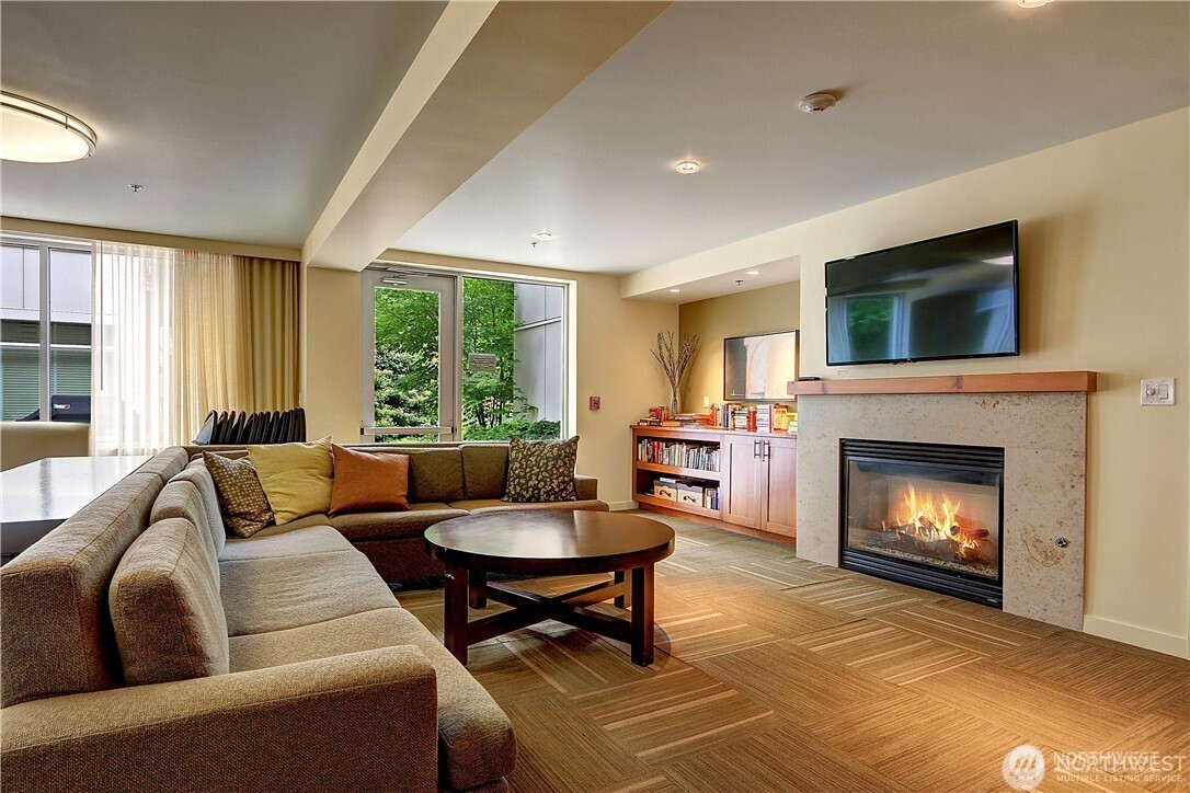 15100 6th Avenue Southwest, Unit 723 Burien, WA 98166 - Photo 19 of 23 a living room with furniture a fireplace and a large window