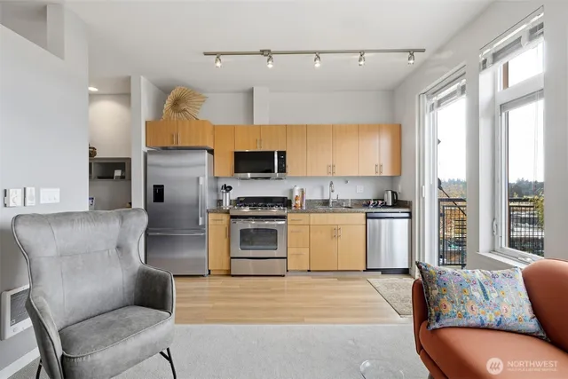 a kitchen with furniture a refrigerator and a stove