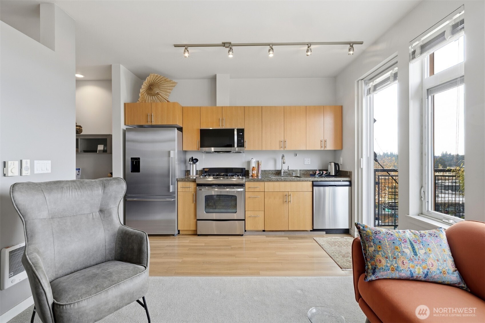 15100 6th Avenue Southwest, Unit 723 Burien, WA 98166 - Photo 3 of 23 a kitchen with furniture a refrigerator and a stove