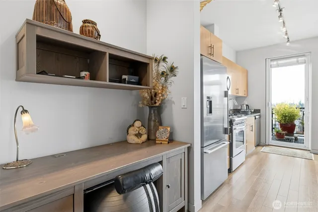 a kitchen with stainless steel appliances a microwave a stove and a refrigerator