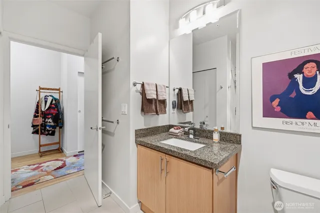 a bathroom with a granite countertop sink and a mirror