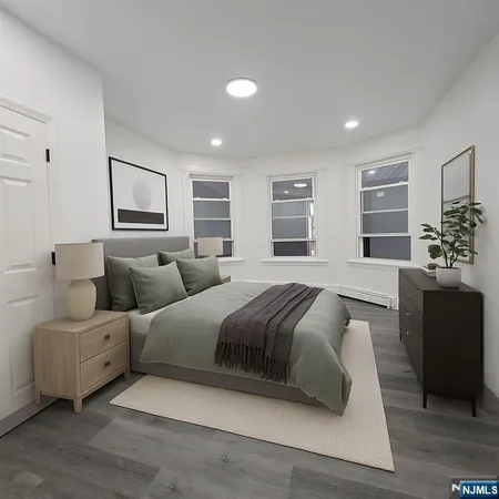 a spacious bedroom with a large bed and furniture