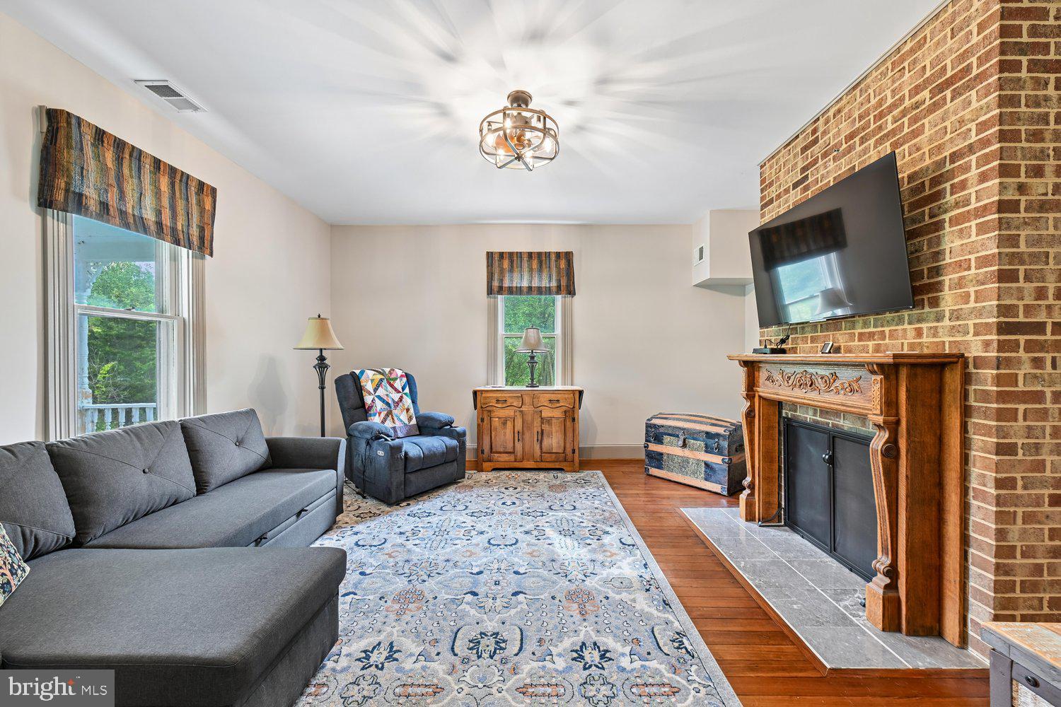 17401 Milltown Landing Road Brandywine, MD 20613 - Photo 12 of 96 a living room with furniture a fireplace and a flat screen tv