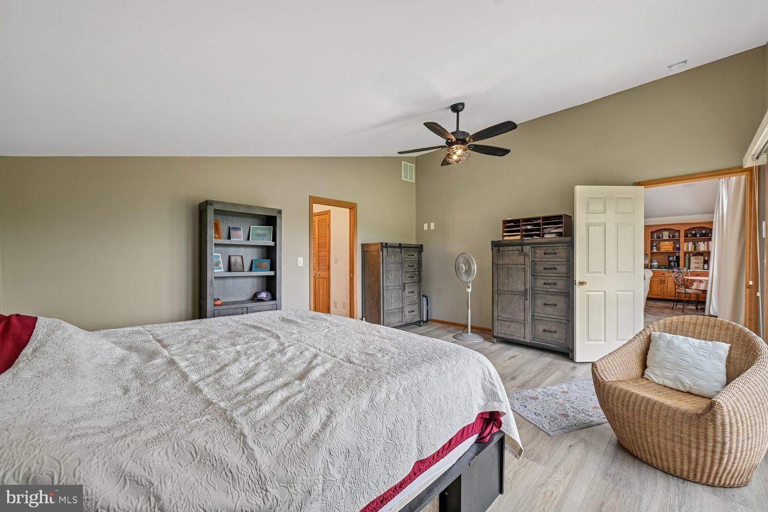 17401 Milltown Landing Road Brandywine, MD 20613 - Photo 45 of 96 a spacious bedroom with a bed a couch and a book shelf