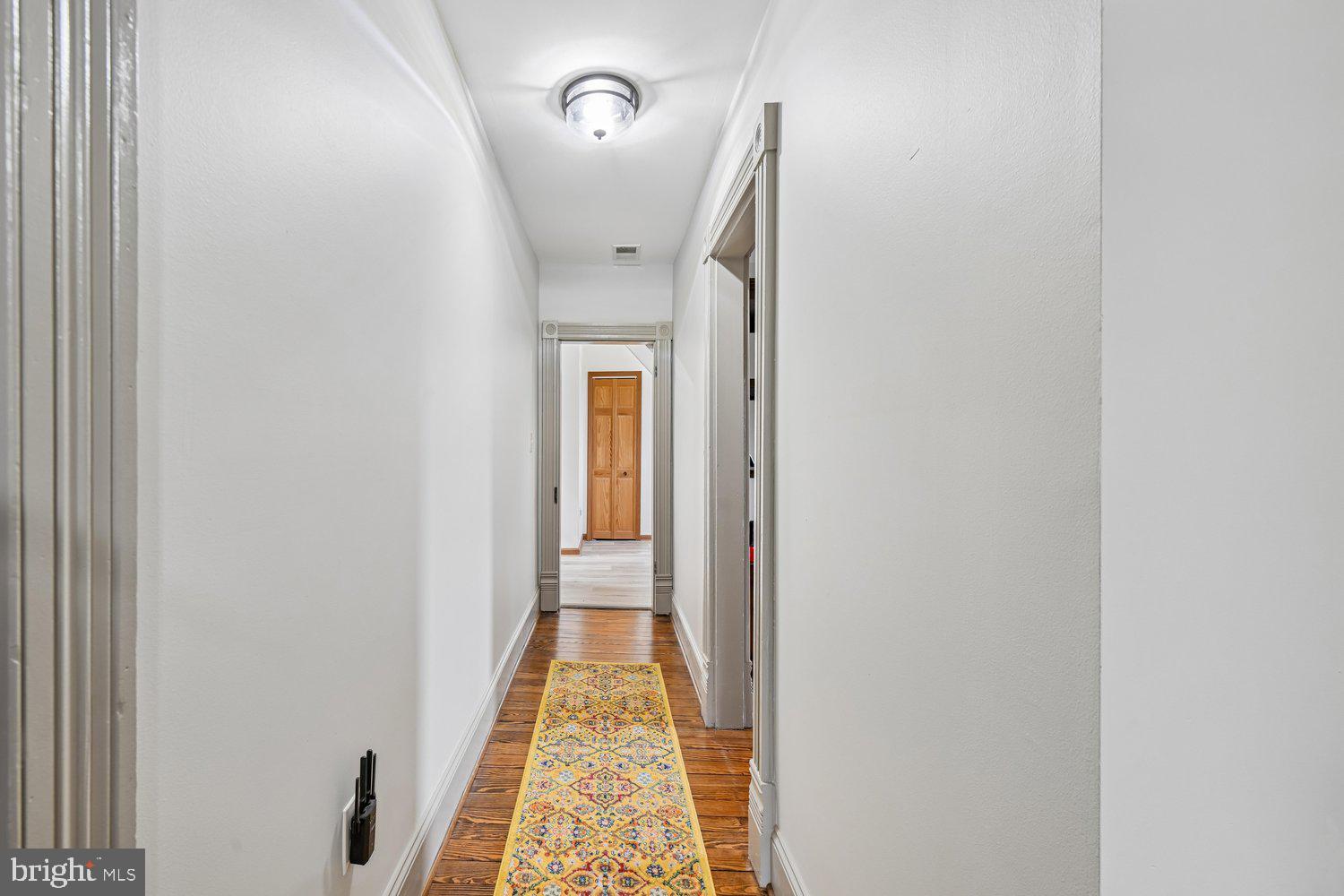 17401 Milltown Landing Road Brandywine, MD 20613 - Photo 69 of 96 a view of a hallway with wooden floor and a bathroom